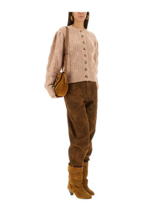 A tan suede crossbody bag with flap closure and adjustable strap paired with isabel marant étoile maxine beige cardigan
