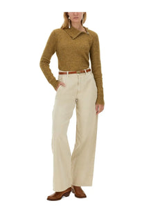 A mustard-yellow textured knit sweater with collar and zipper detail paired with Isabel Marant Étoile pink jeans