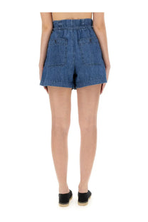 Back view of isabel marant étoile women’s high waisted medium blue wash denim shorts with elastic waistband and two pockets