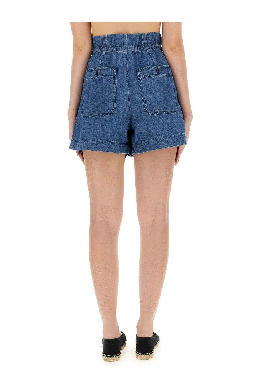 Back view of isabel marant étoile women’s high-waisted medium blue denim shorts with elastic waistband and two pockets