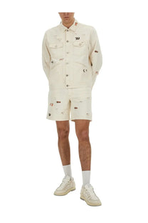 Isabel marant men’s bermuda shorts jerryl white styled with a cream-colored distressed denim jacket with embroidered patches and red detailing