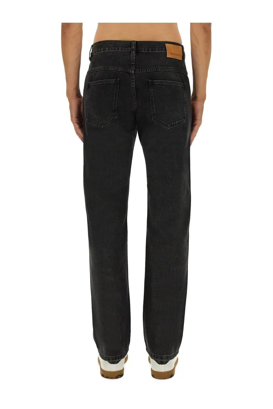Back view of Isabel Marant men’s black denim jeans with straight-leg cut and brown leather brand patch on waistband
