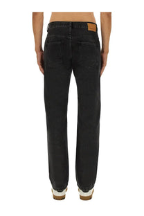 Back view of Isabel Marant men’s black denim jeans with straight-leg cut and brown leather brand patch on waistband