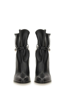 Isabel Marant women’s black leather ankle boots with a sleek glossy finish and decorative ankle straps