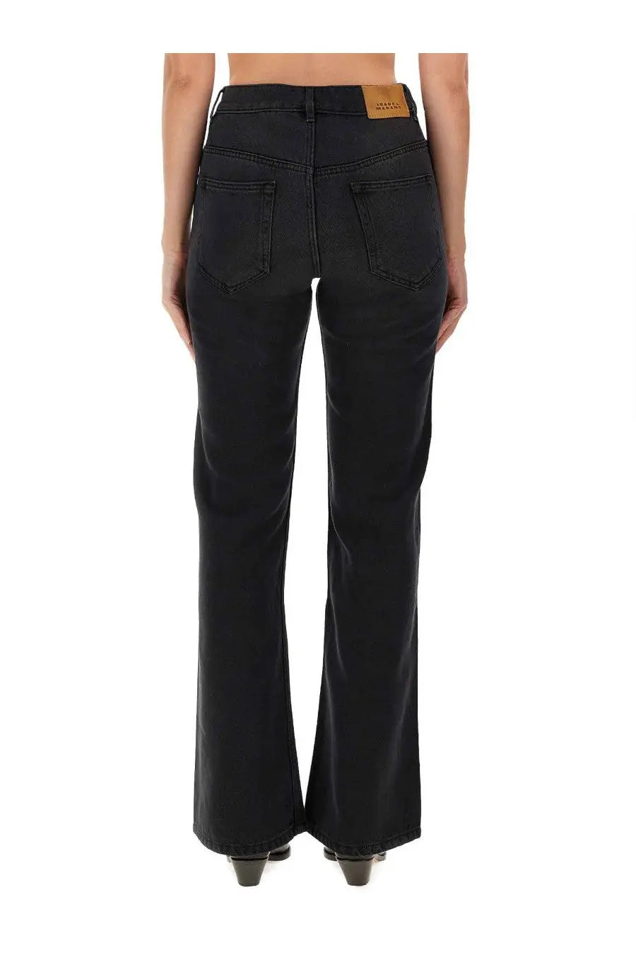 Black denim flare jeans for women by isabel marant featuring a brown leather brand patch at the waistband back view