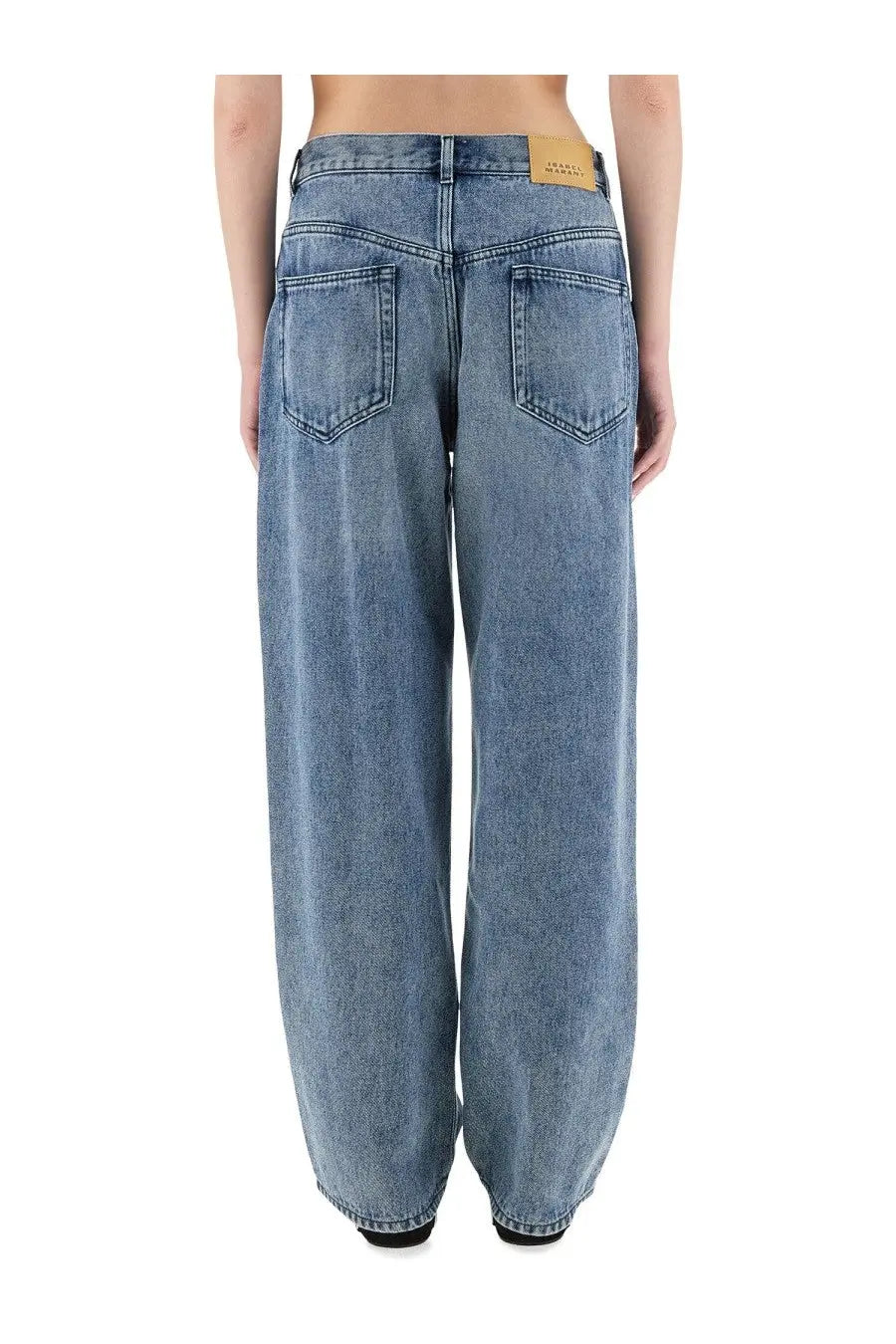 Back view of isabel marant women’s light-wash denim wide-leg jeans with classic back pockets and tan leather patch