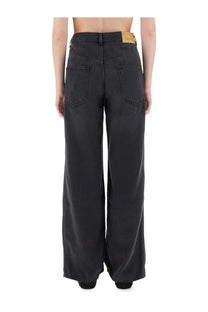 Back side of Isabel Marant women’s black wide-leg denim jeans with high waist two back pockets and tan leather label