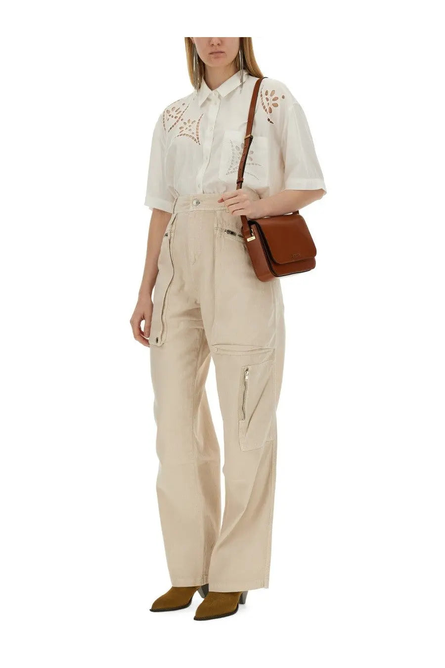 Brown leather crossbody bag with flap closure and adjustable strap paired with Isabel Marant women’s pink pants