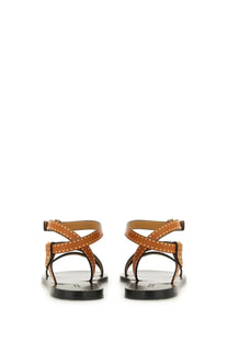 Isabel marant women’s tan leather sandals with gold-tone studs and black rubber soles shown from the back