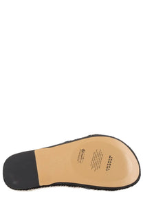 The sole of a black and tan isabel marant women’s sandalo kitza sandal with textured rubber heel and stitched edge