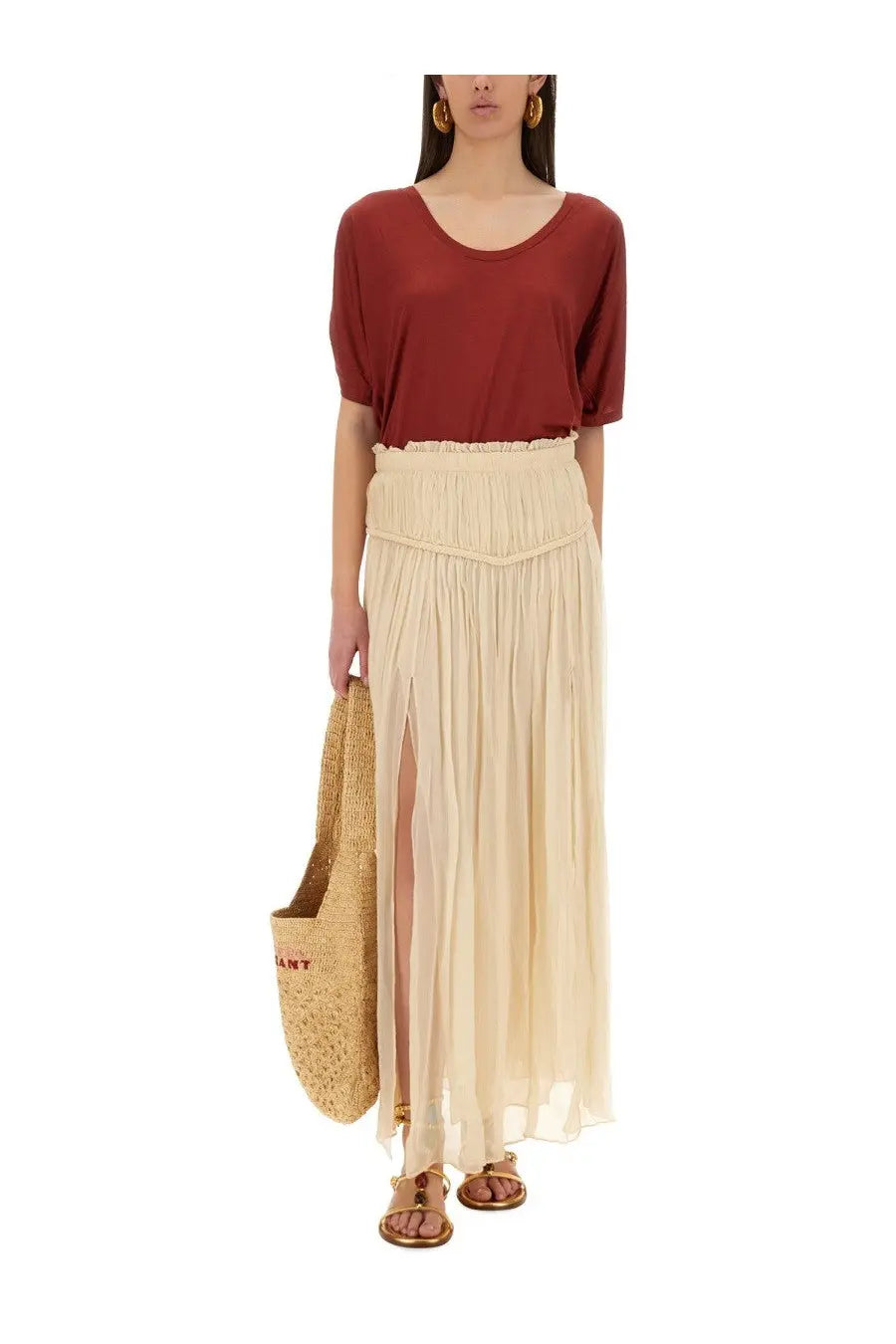 Beige pleated maxi skirt with high waisted elastic band and side slit paired with isabel marant emmanuela red shirt