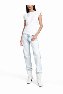 Light-wash denim jeans with relaxed fit and subtle distressing along the seams paired with isabel marant white shirt