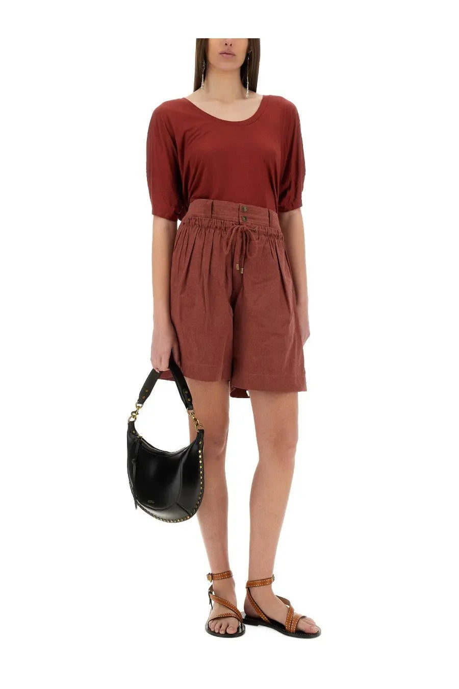 Black leather hobo bag with gold-tone hardware and studded trim shown with isabel marant womens shorts ingrid red