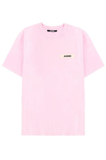 A soft pink minimalist jacquemus t-shirt with subtle brand labels on chest and neckline for casual wear