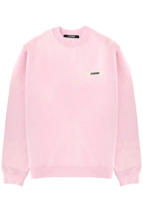 A soft pink jacquemus crewneck sweatshirt with minimalist design and branded labels on chest and collar
