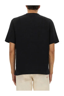 Back view of jacquemus men’s la maglietta gros grain black short-sleeved t-shirt with red logo on lower back