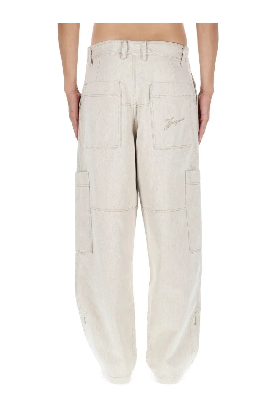 Beige jacquemus men’s le cargo de nimes carré pants shown from the back with multiple pockets and embroidered logo