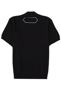Back view of jacquemus men’s le polo maille black short-sleeved knit sweater with white outlined hexagonal patch