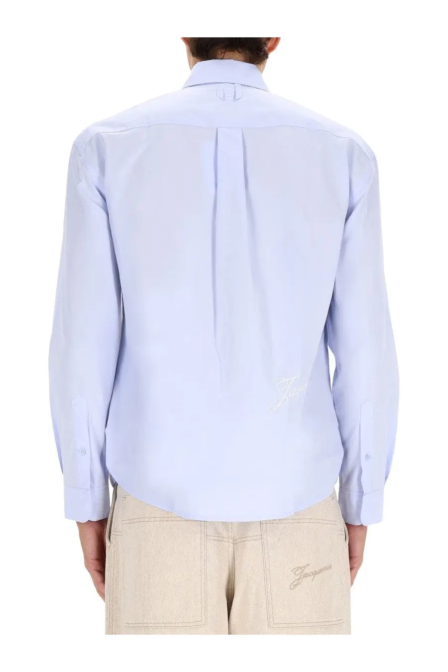 Light blue jacquemus men’s le simon long-sleeved shirt with subtle pleated back and embroidered logo on lower left side
