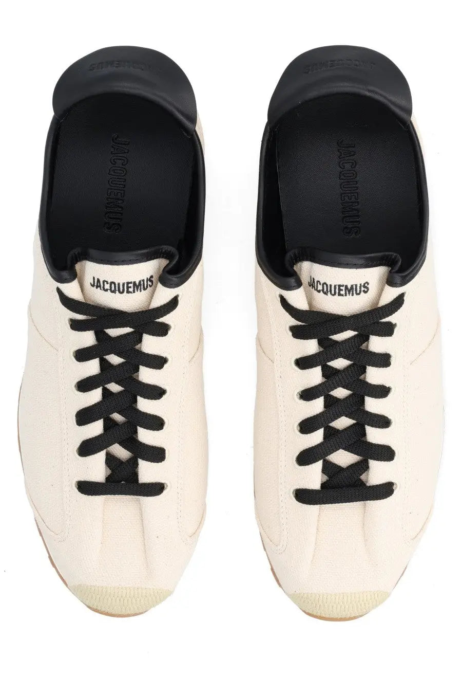 Cream-colored canvas jacquemus men’s les tennis sneaker with black laces and rubber toe caps in beige
