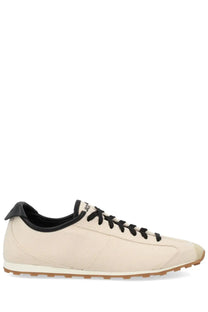 Cream-colored canvas jacquemus men’s les tennis sneaker with black laces tongue and heel tab
