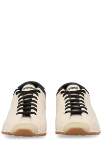Cream-colored leather jacquemus men’s les tennis sneaker with black laces and tan rubber sole in beige