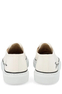 Cream-colored jacquemus men’s canvas sneakers with black piping thick white rubber sole and embroidered heel logos back view