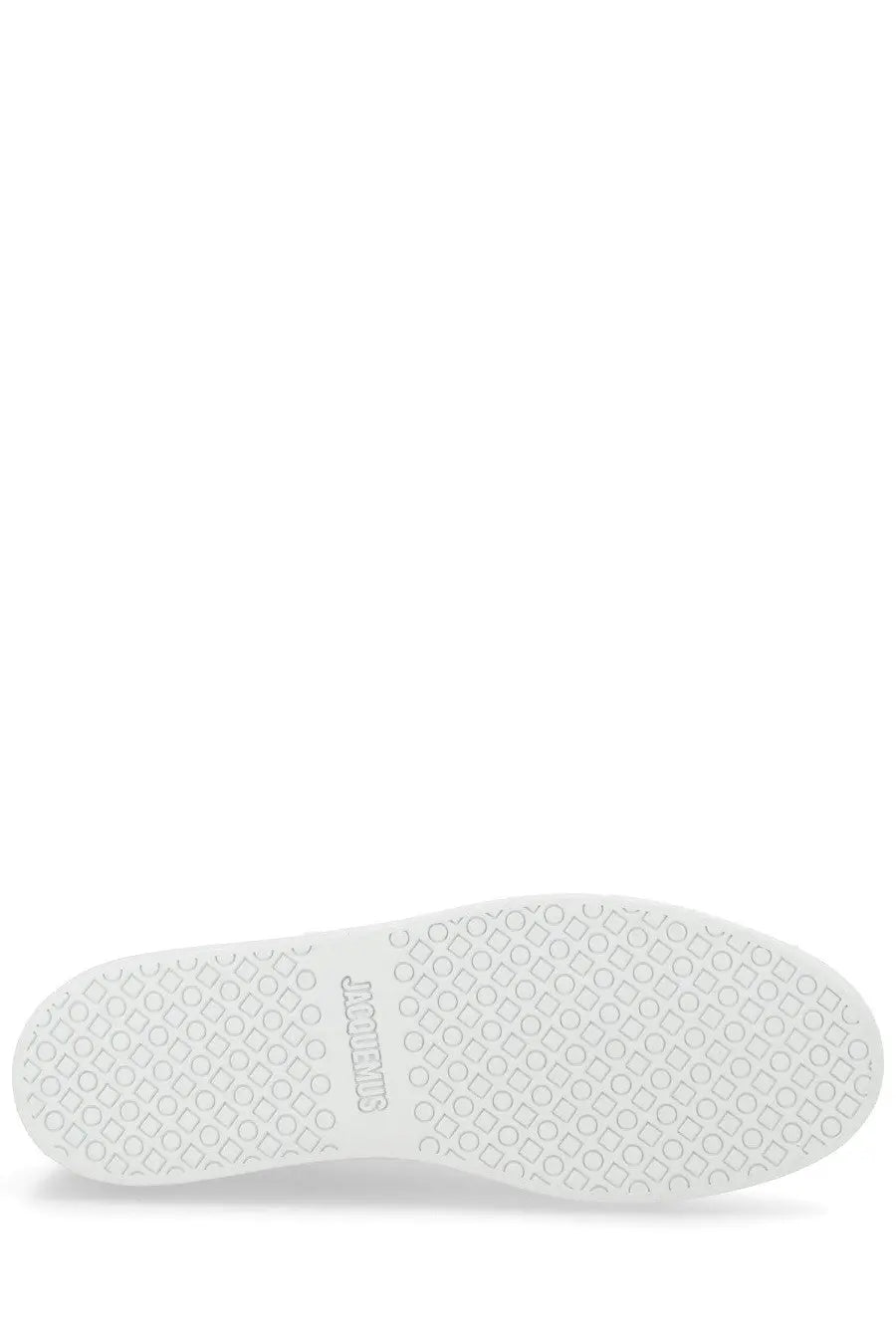 Back side of jacquemus men’s sneaker É É white with a white rubber sole patterned with interlocking circles and squares and comme des garcons logo embossed on the heel