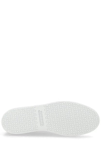 Back side of jacquemus men’s sneaker É É white with a white rubber sole patterned with interlocking circles and squares and comme des garcons logo embossed on the heel