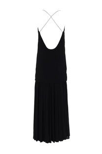 Black sleeveless jacquemus abiha long dress with cross-back design and pleated skirt shown from the back side