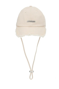 Cream-colored jacquemus women’s artichaut baseball cap with soft fuzzy trim and adjustable drawstring in white