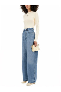 Cream-colored leather clutch with minimalist design and gold-tone hardware paired with jacquemus beige long sleeved shirt