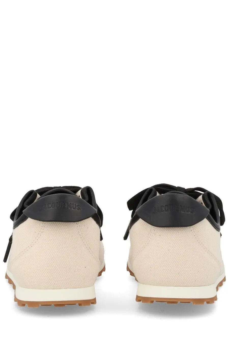 Beige canvas jacquemus womens sneaker tennis with black rubber heel tabs and soles in minimalist design back view