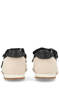 Beige canvas jacquemus womens sneaker tennis with black rubber heel tabs and soles in minimalist design back view