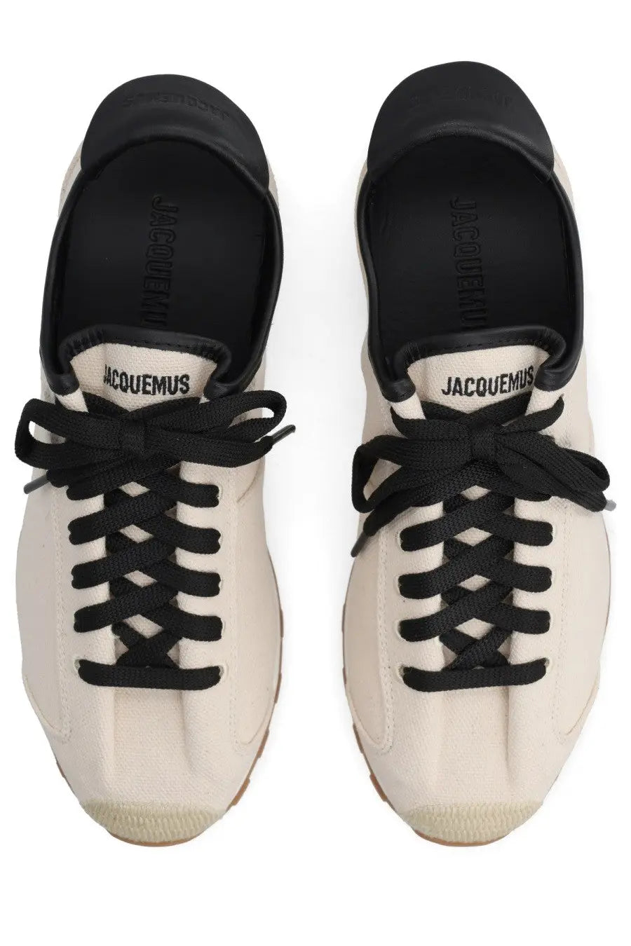 Cream-colored suede jacquemus women’s sneaker with black laces and rubber toe cap in tennis beige style