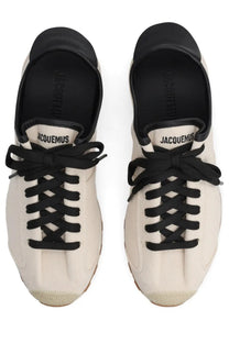 Cream-colored suede jacquemus women’s sneaker with black laces and rubber toe cap in tennis beige style