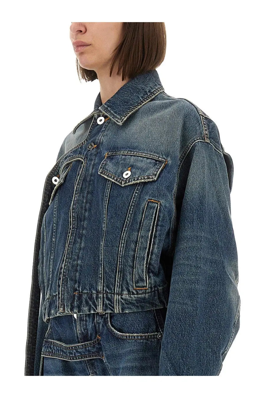 Jean Paul Gaultier women’s denim jacket blue with faded blue wash black sleeves and white buttons front view