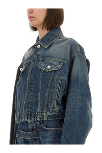 Jean Paul Gaultier women’s denim jacket blue with faded blue wash black sleeves and white buttons front view