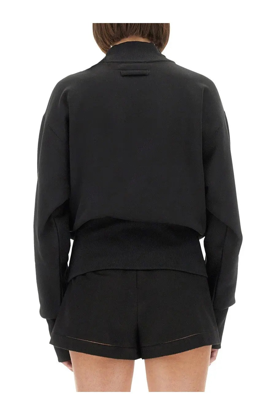 Black cropped bomber jacket with ribbed cuffs and waistband from Jean Paul Gaultier women’s jpg sweatshirt collection