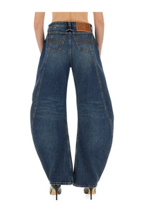 Dark blue denim jean paul gaultier women’s low rise wide-leg jeans with brown leather brand patch at waistband back view