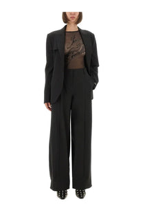 Black tailored blazer with structured fit and single-breasted design paired with jean paul gaultier women’s black pants