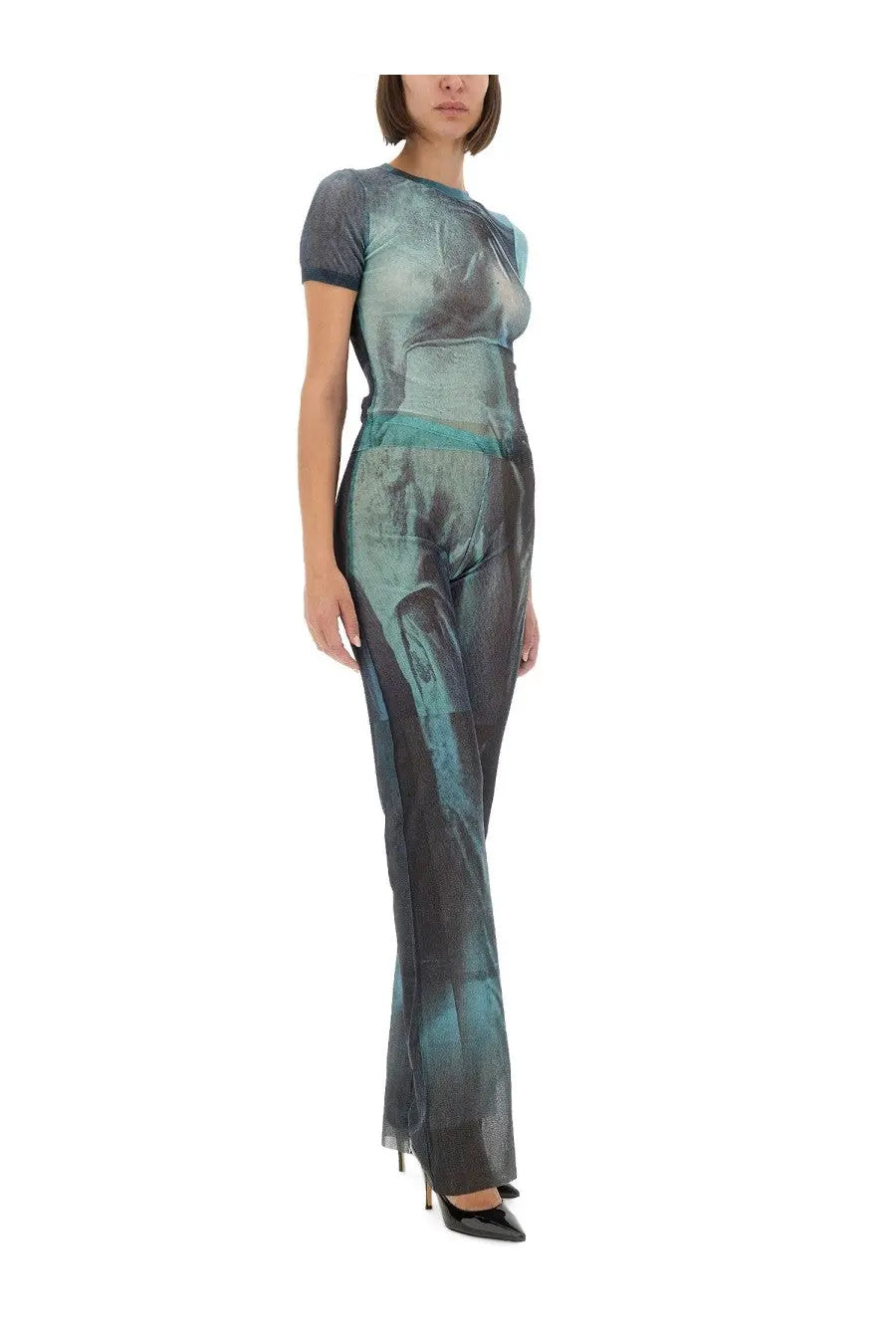 A sleek jumpsuit in teal and dark gray gradient with abstract semi-transparent print for women by Jean Paul Gaultier