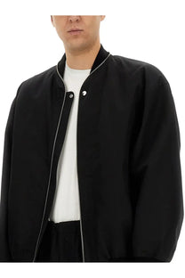 Jil Sander men’s black bomber jacket with silver zipper and snap buttons in durable fabric for stylish outerwear