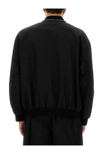 Jil sander men’s black bomber jacket featuring a subtle chain detail along the collar in sleek material