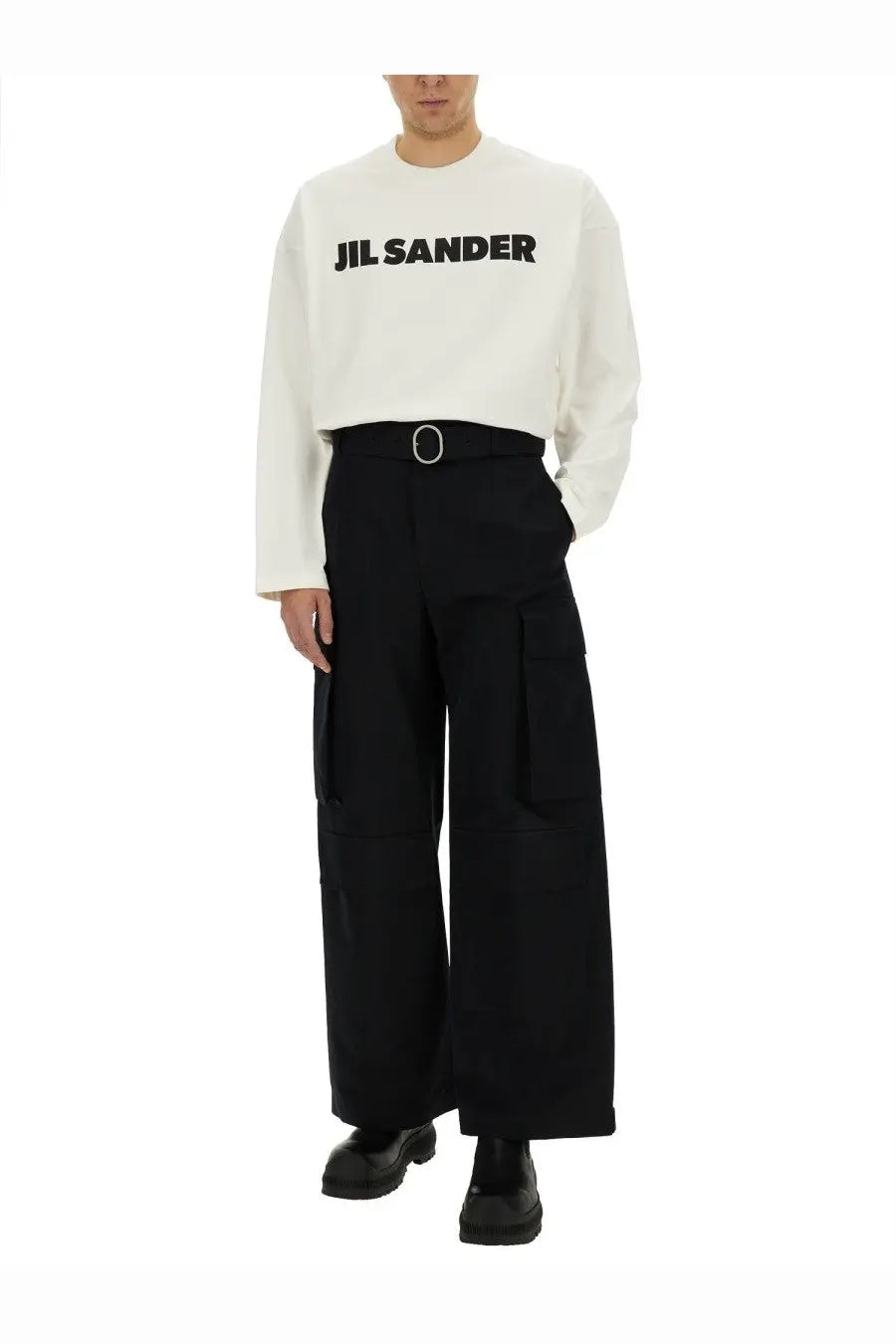 White jil sander long sleeve crewneck sweatshirt with bold black lettering across the chest paired with black cargo pants