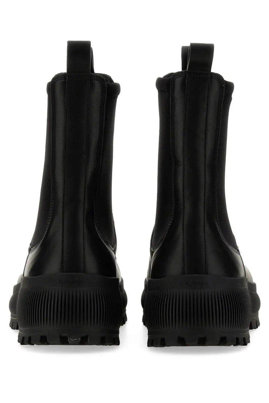 Jil Sander men’s Chelsea boot in black leather with a chunky ribbed rubber sole shown from the back side