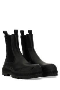 Jil sander men’s black rubber chelsea boot with chunky ribbed sole and elastic side panels for easy wear
