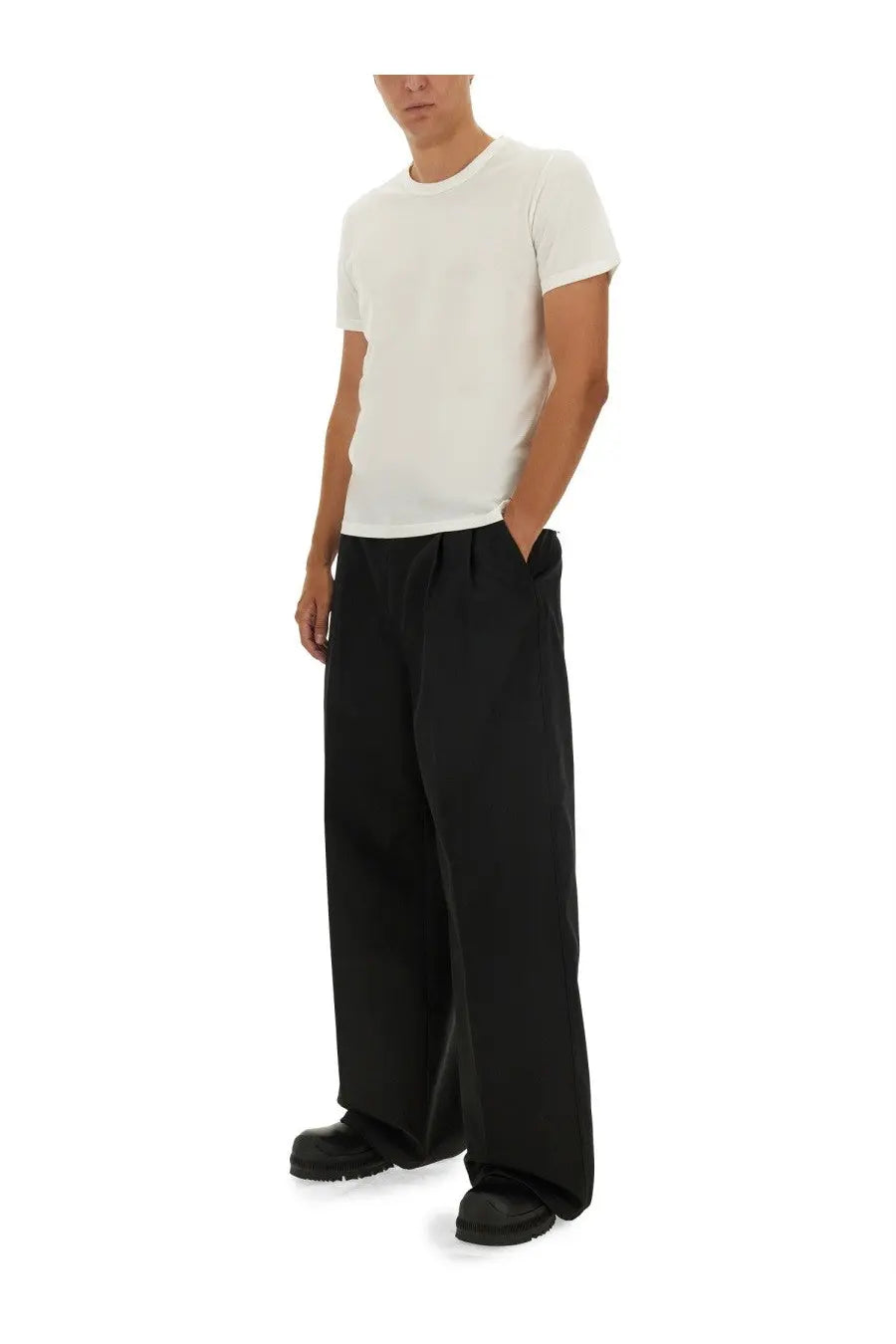 Black wide-leg cotton trousers with a relaxed minimalist design paired with jil sander men’s white cotton shirt