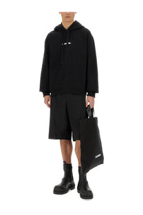 Black canvas tote bag with white jil sander logo on the side designed for daily use and casual carry