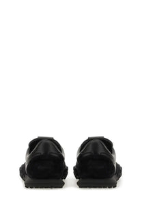 Jil Sander men’s low top sneaker in black leather with a chunky rubber sole and minimalist design